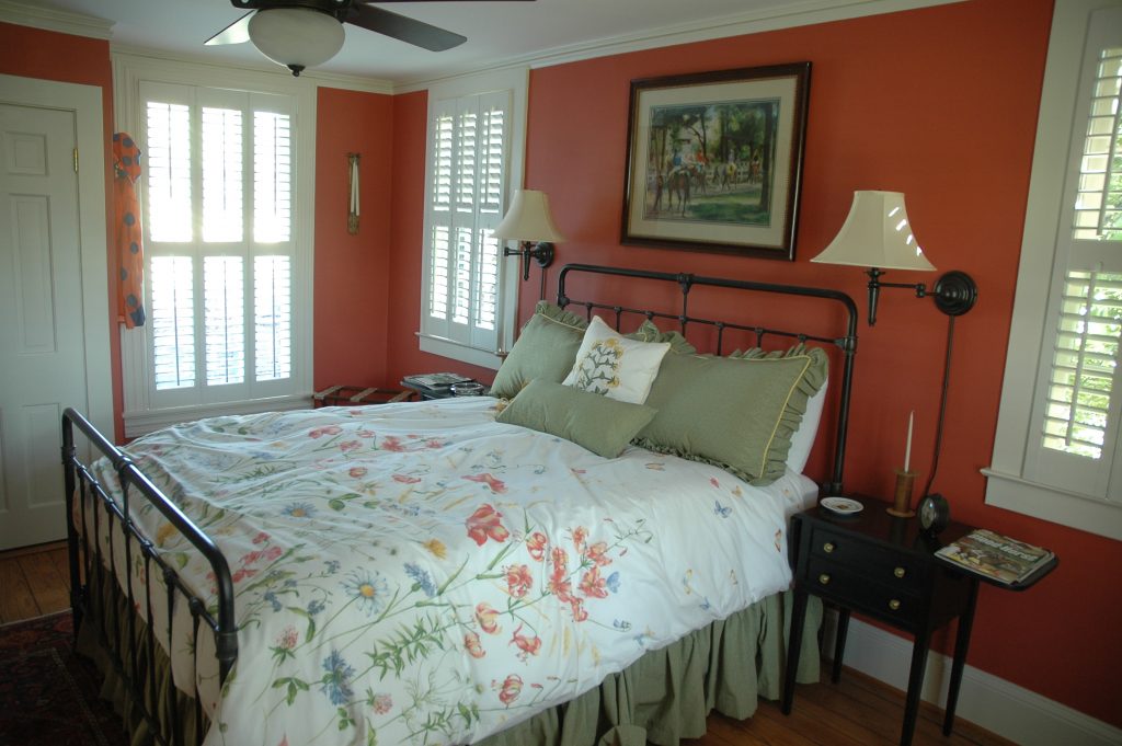 The red queen room faces the track and is just steps to a shared full bath.